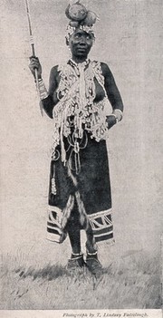 A Zulu medicine woman or shaman practising in Basutoland, South Africa. Halftone after a photograph by L. Fairclough.