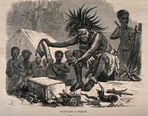 view An African medicine man or shaman using symbols and small animals to eject a demon (disease). Wood engraving by Dalziel after J. Leech.