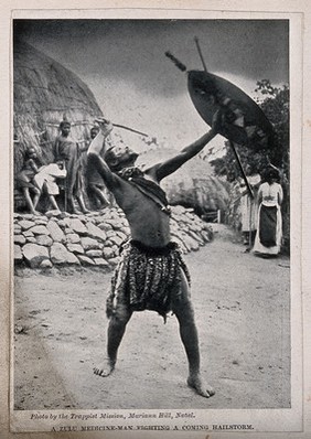 A Zulu medicine man or shaman performing a ritual to fend off a hailstorm, South Africa. Halftone after Trappist Mission, Natal.