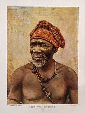 A South African medicine man or shaman. Colour process print after a photograph by G.W. Wilson.