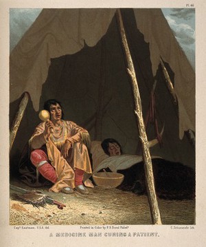 view A native North American shaman or medicine man healing a patient. Chromolithograph by C. Schuessele after Captain Eastman.