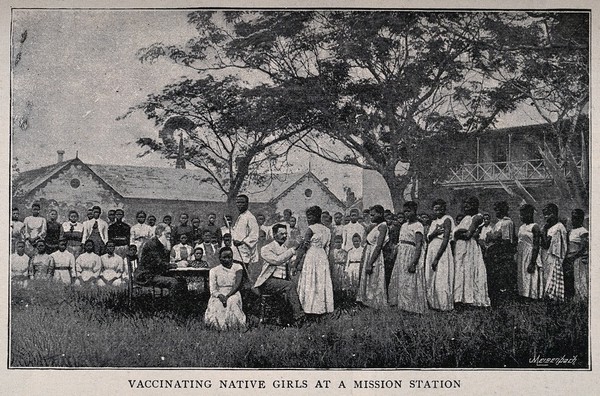 A white doctor vaccinating African girls all wearing European clothes at a mission station. Process print by Meisenbach after a photograph.