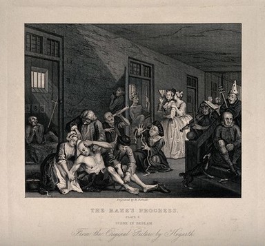 An insane man (Tom Rakewell) sits on the floor manically grasping at his head, while two attendants manacle his legs: his lover, Sarah Young, cries in distress, they are surrounded by lunatics at Bethlem hospital, London. Engraving by H. Fernell after W. Hogarth, 1735.