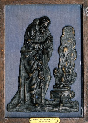 view Winter: an old man warming his hands before a brazier. Wax sculpture.