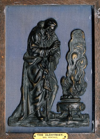 Winter: an old man warming his hands before a brazier. Wax sculpture.