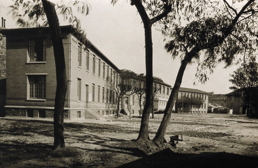 Two storey brick building (in France?) Photograph, ca. 1950.