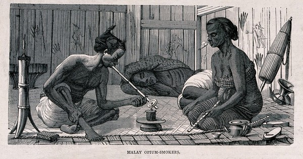 Two Malay men and a woman sit and recline on the floor smoking opium. Wood-engraving, late 19th century.