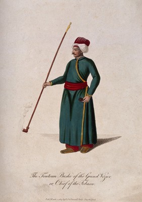 A Turkish official in robe and turban holding a long-stemmed pipe. Coloured stipple print, c. 1803.
