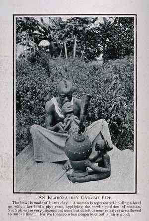 view An African chief smoking a very elaborately carved tobacco-pipe. Process print.