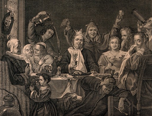 King drinking at a table surrounded by revelling courtiers