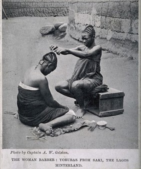 A Yoruba female hairdresser dressing the hair of a woman. Halftone after A.W. Gelston.