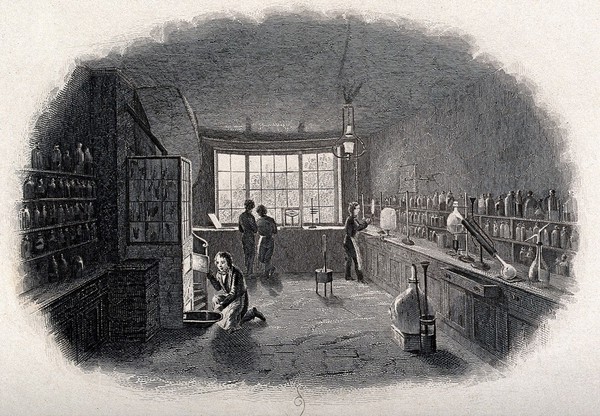 A chemical laboratory with four chemists; one looks into a furnace. Engraving.