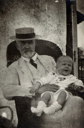 Anton Freiherr von Eiselsberg with a baby. Photograph.