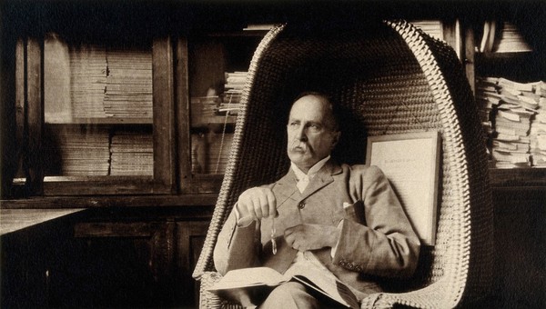 Sir William Osler in Edward Jenner's chair in the room of the Regius Professor of Medicine, University Museum, Oxford. Photograph.