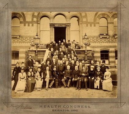 Health Congress, Brighton: group of about sixty delegates assembled on hotel (?) entrance steps. Photograph, 1890.