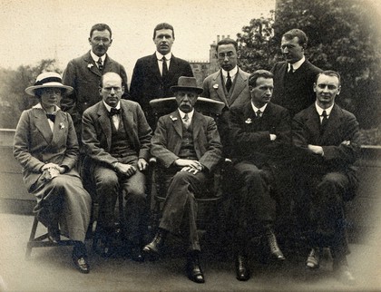 International Congress of Medicine (17th), London, 1913: Henry O. Feiss, orthopaedist, included in group portrait of eight men and one woman. Photograph, ca. 1913.