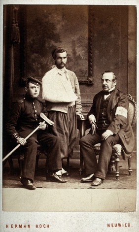 Franco-Prussian War: Ernest de Bunsen with two wounded soldiers in the Rhineland-Palatinate. Photograph by Herman Koch, ca. 1870.