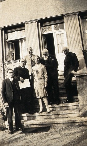Leipzig, Germany: medical historians posing on the steps of a building: group portrait. Photograph, 1929.