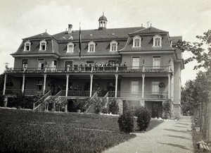 view Vienna (?), Austria: a large house with people grouped on the verandah. Photograph, ca. 1918.