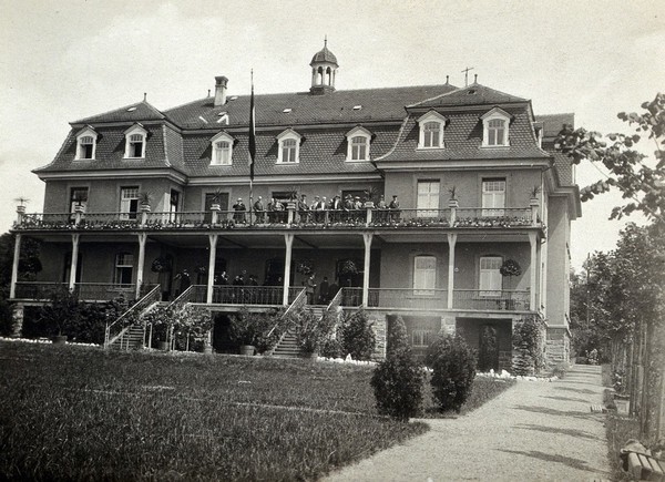 Vienna (?), Austria: a large house with people grouped on the verandah. Photograph, ca. 1918.