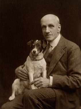 Charles Firmin Cuthbert with dog. Photograph by Debenham, 1923.