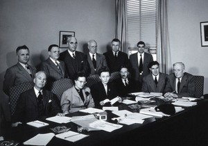 view A meeting of twelve scientists on tropical medicine. Photograph.