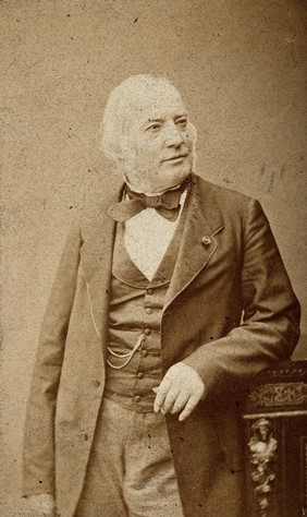 An unidentified man leaning on a cabinet. Photograph by Fredd. Mulnier.