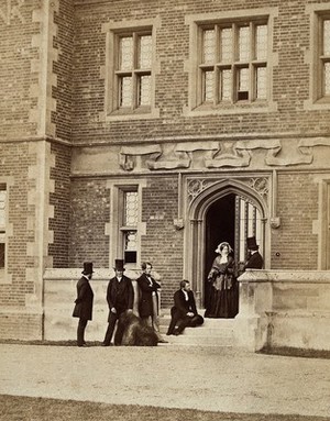 view Group of six people with a sheepdog. Photograph.