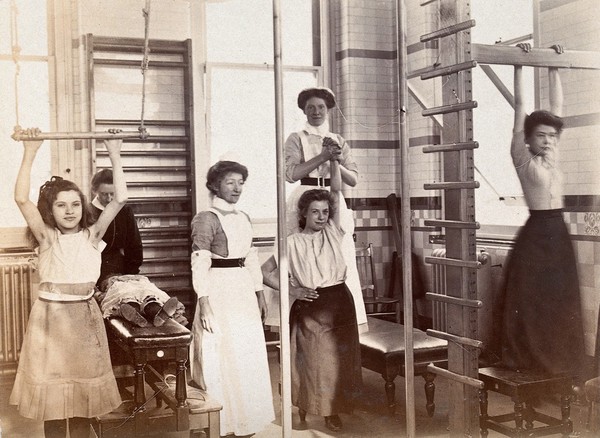 St Bartholomew's Hospital, London: nurses and patients exercising in the gymnasium. Photograph, c.1890.