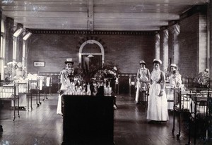 view St Bartholomew's Hospital, London: nurses in a ward. Photograph, c.1908.