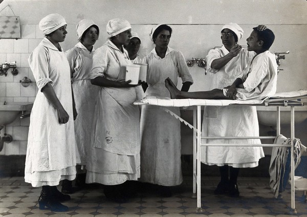 University Children's Hospital, Vienna: nurses examining a boy's mouth. Photograph, 1921.