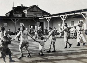 view University Children's Hospital, Vienna: children playing in the outdoor section. Photograph, 1921.