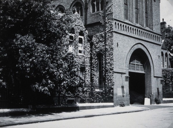 St Charles Hospital, London: the archway and the Medical Superintendent's house. Photograph, c. 1930.