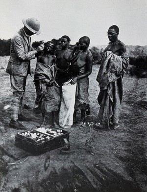 view A medical officer taking a sample of blood from an inhabitant of Buruma Island, suffering from sleeping sickness. Photograph, 1965, after photograph 1902.