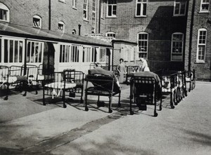 view St Nicholas' and St Martin's Orthopaedic Hospital, Pyrford, Surrey: hospital beds outdoors. Photograph, c. 1935.