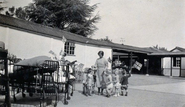 St Nicholas' and St Martin's Orthopaedic Hospital, Pyrford, Surrey: children with union jack flags. Photograph, c. 1935.