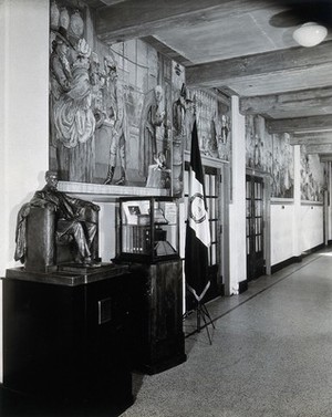 view Philadelphia College of Pharmacy and Science: the foyer, with tribute to Sir Henry Wellcome in glass case, on the occasion of his knighthood. Photograph, c. 1933.