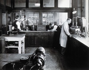 view Philadelphia College of Pharmacy and Science: students in a laboratory analysing chemicals. Photograph, c. 1933.