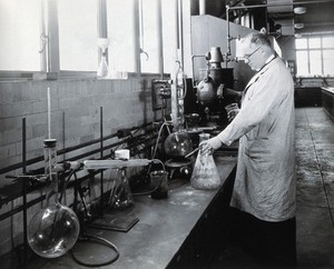 view Philadelphia College of Pharmacy and Science: man in a lab. Photograph, c. 1933.