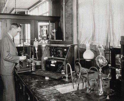 Philadelphia College of Pharmacy and Science: a man experimenting in a laboratory. Photograph, c. 1933.