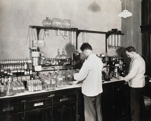 view Philadelphia College of Pharmacy and Science: two men working in a laboratory. Photograph, c. 1933.