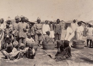 view Disinfecting sufferers of the plague in wooden tubs, Karachi, India. Photograph, 1897.