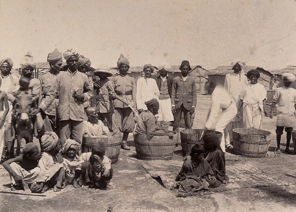 Disinfecting sufferers of the plague in wooden tubs, Karachi, India. Photograph, 1897.