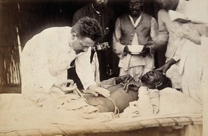 view Man being injected by doctor, during the outbreak of bubonic plague in Karachi, India. Photograph, 1897.