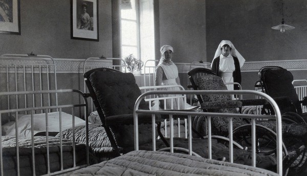 British Red Cross Hospital, Turin: hospital ward with nurses. Photograph, c. 1918.