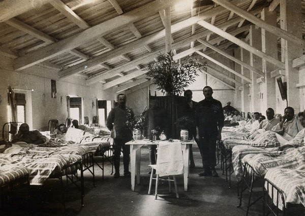 British Red Cross Hospital, Turin: hospital ward with male patients. Photograph, c. 1918.