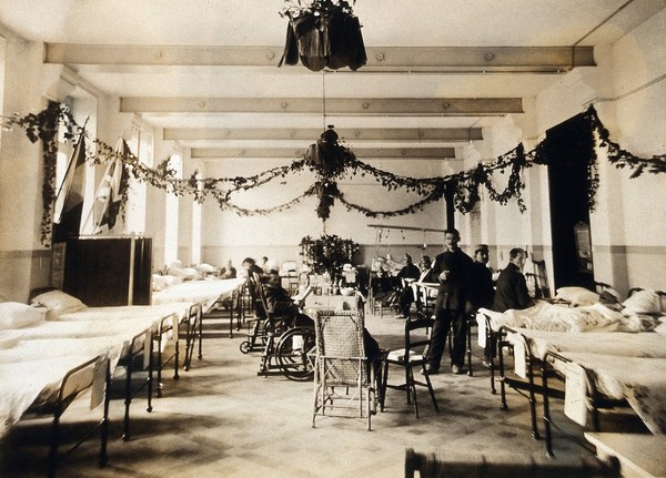 Military Hospital V.R. 76, Ris-Orangis, France: a ward, decorated, possibly for Christmas. Photograph, 1916.