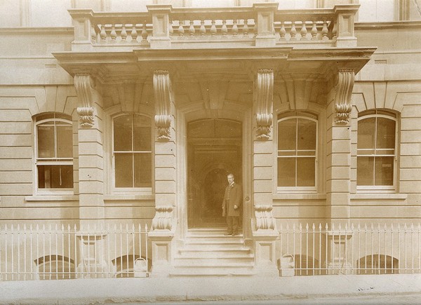 The Royal United Hospital, Bath: a man on the steps of the Prince Albert memorial wing. Photograph, ca. 1870.