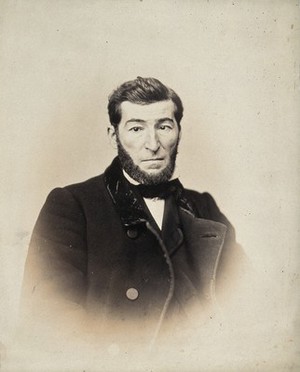 view A bearded man, head and shoulders; his left eye points inwards, while his right eye points straight ahead. Photograph by L. Haase after H.W. Berend, 1863.