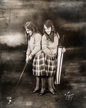 Daisy and Violet Hilton, conjoined twins, dressed for golf. Photograph, c. 1927.